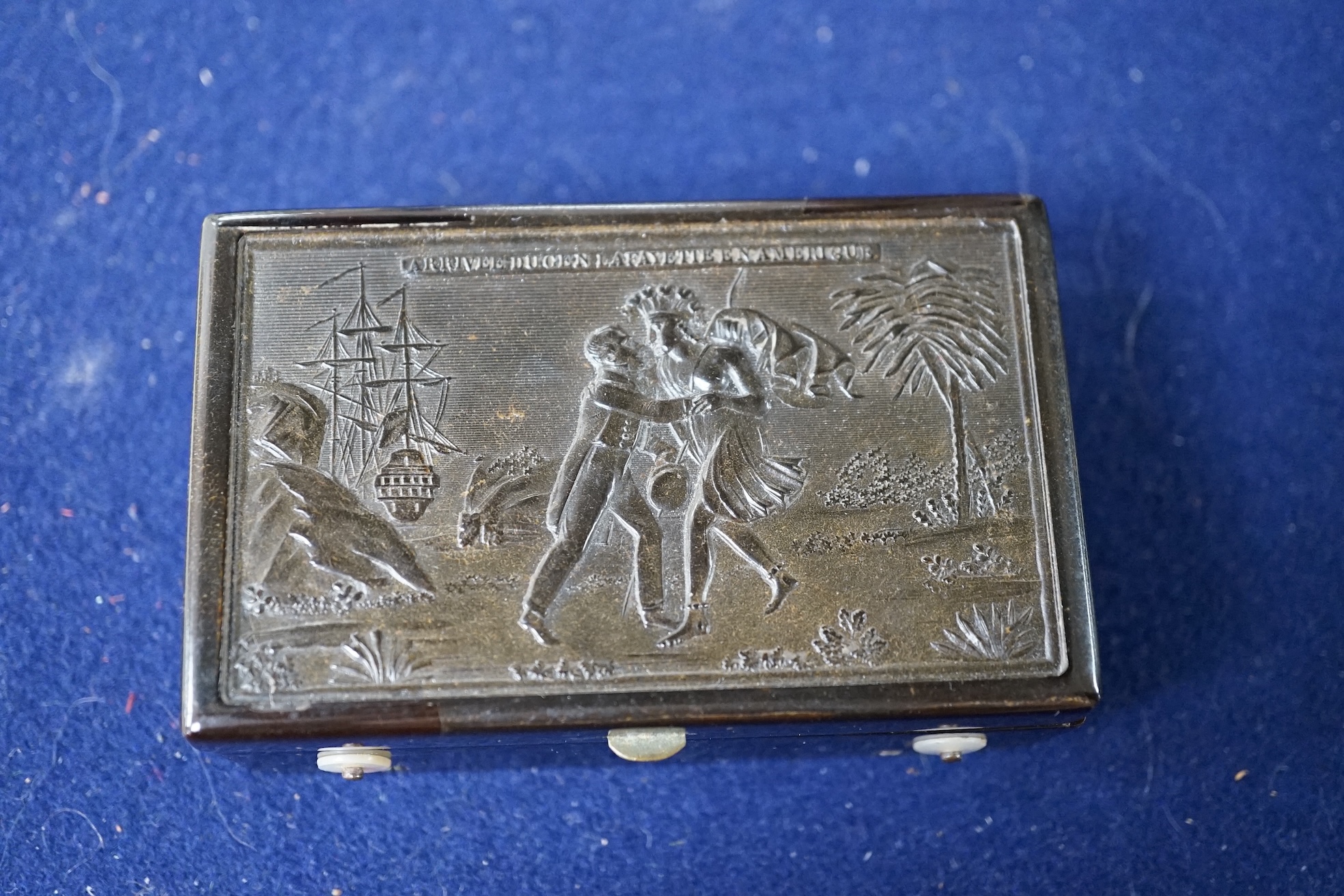 A 19th century Swiss small cylinder tortoiseshell musical snuff box, the hinged lid decorated with a scene of General Lafayette landing in America, with 6.5cm. cylinder, inscribed 'Arrivee du Gen Lafayette en Amerique',